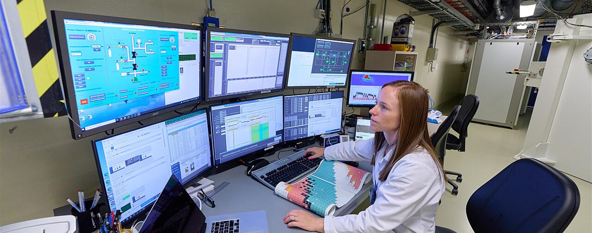 University Researcher in Front of a Bank of Computers