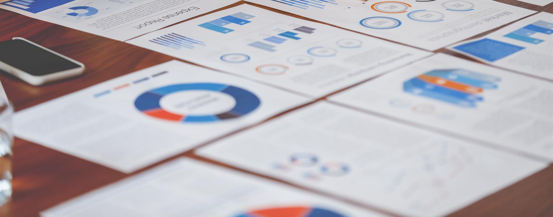 Photo of colorful charts and graphs laid out on a table